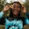 girl smiling with flower on her ear